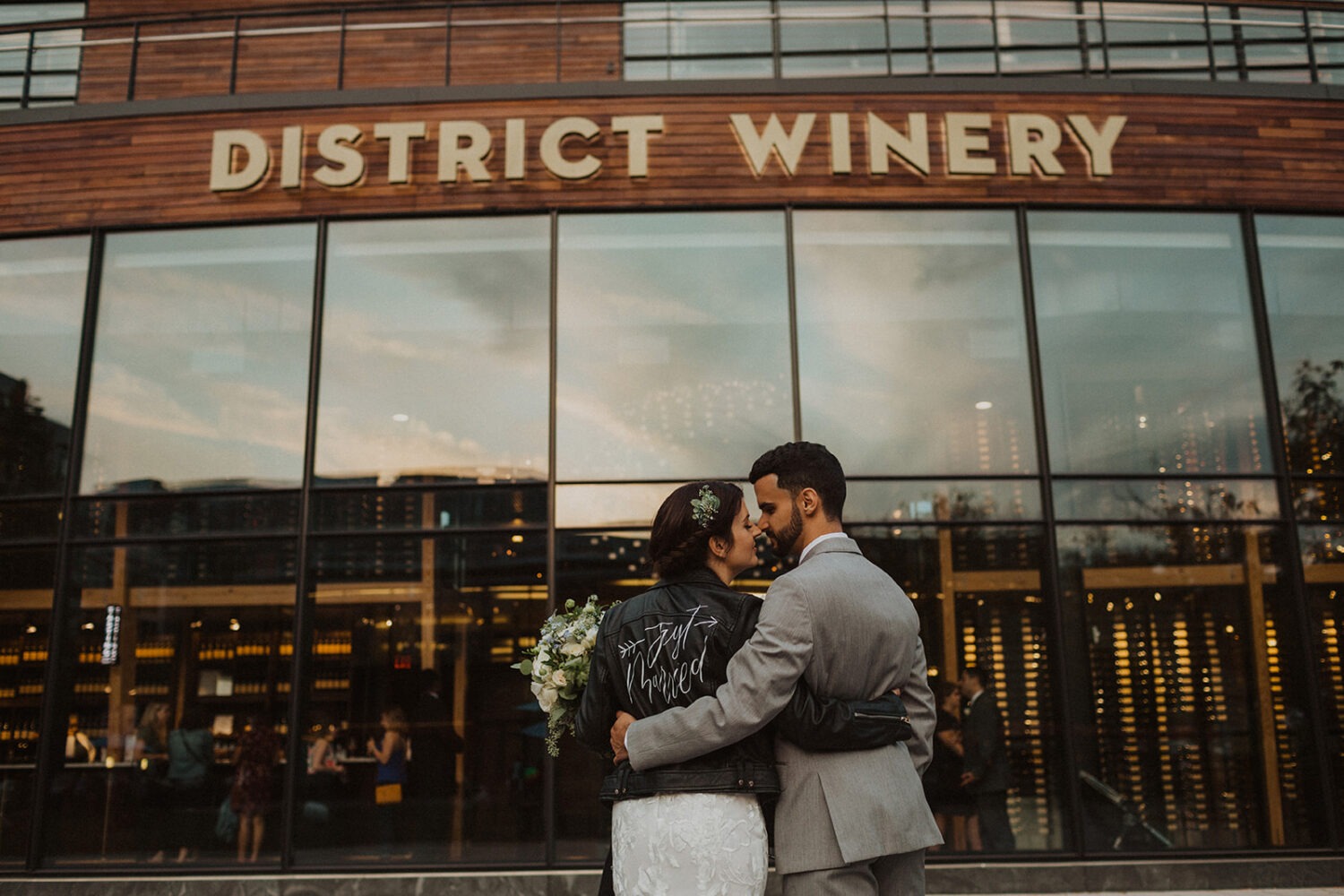 couple embraces in front of winery wedding venue
