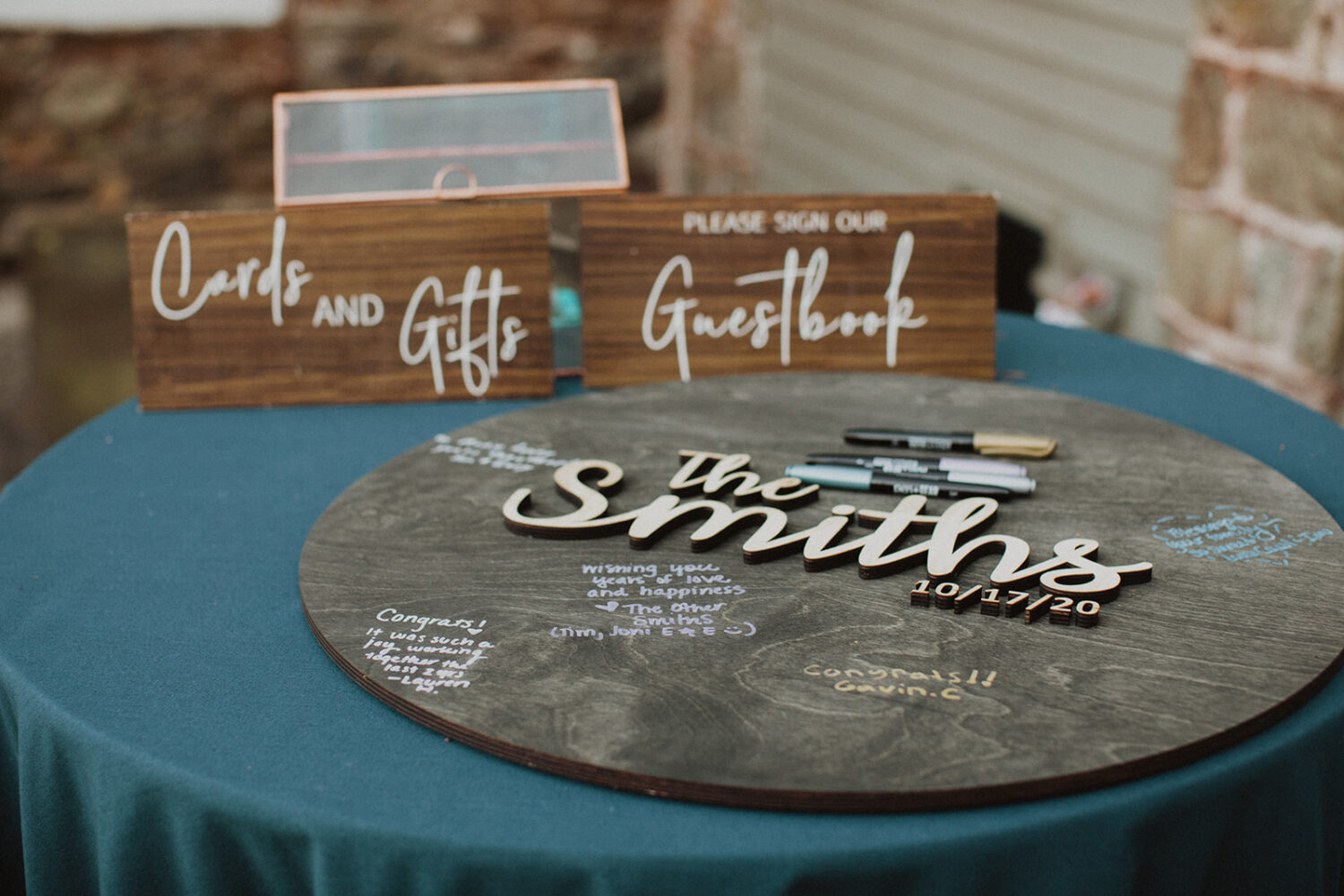 wooden sign with last name as example of 2024 wedding trends