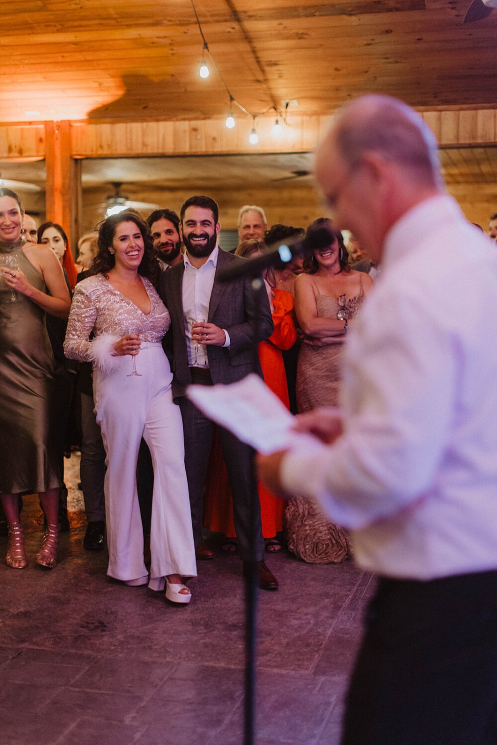 bride wears white jumpsuit as example of 2024 wedding trends