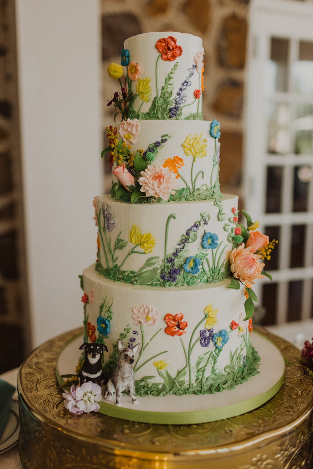 textured cake with flowers and dog figurines 