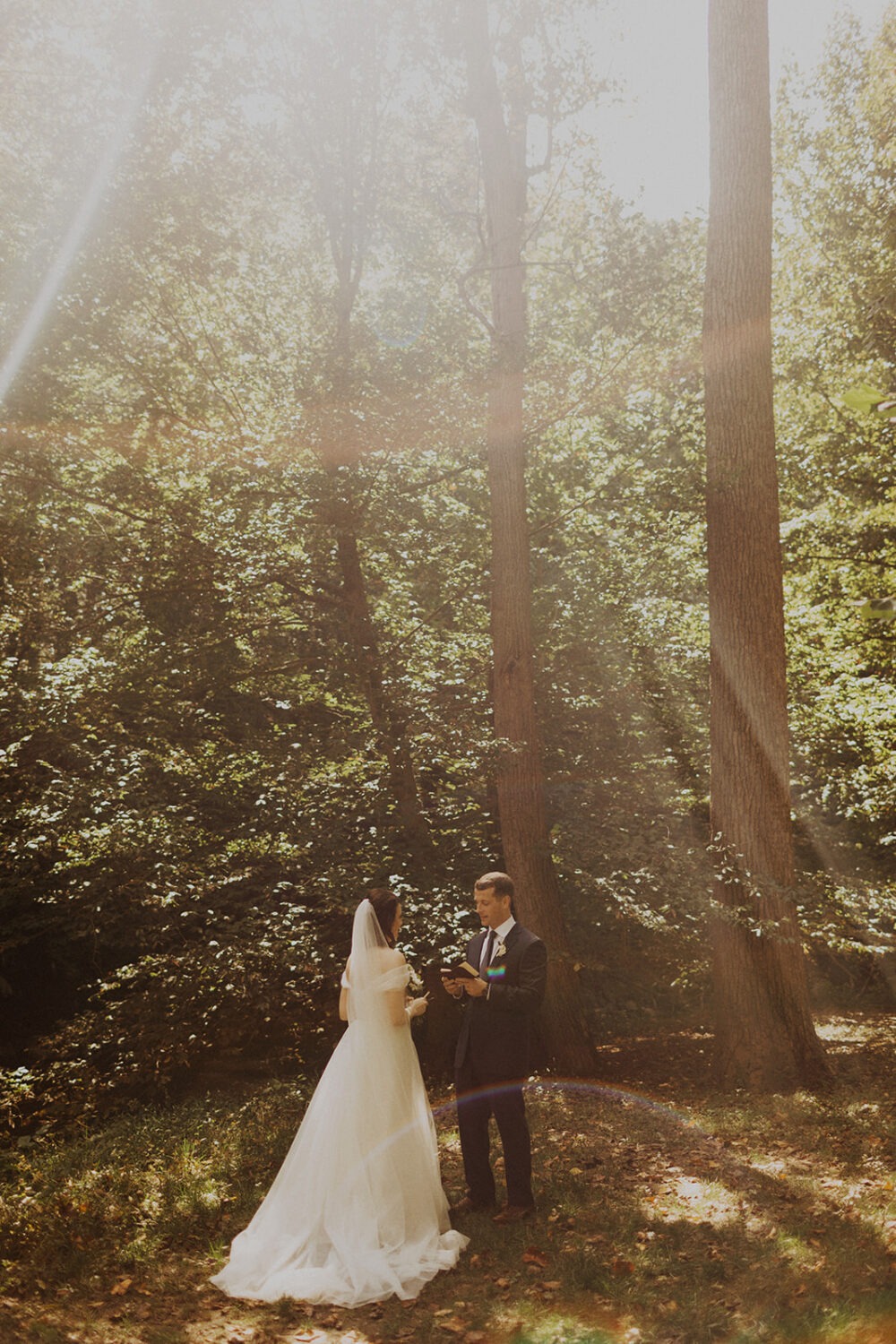 couple exchanges vows at forest sunset elopement