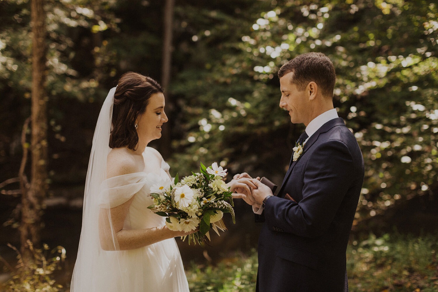 couple exchanges vows at forest sunset elopement