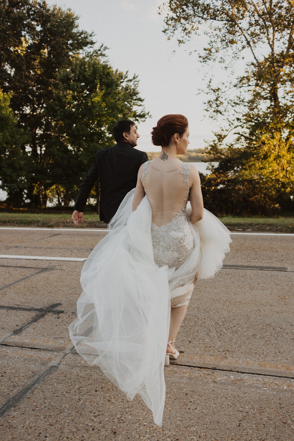 couple crosses street at wedding reception