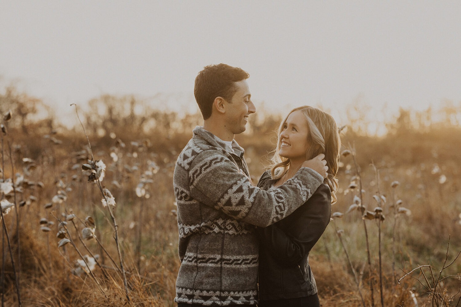 couple embraces in sunset field for Rock Creek Park photos