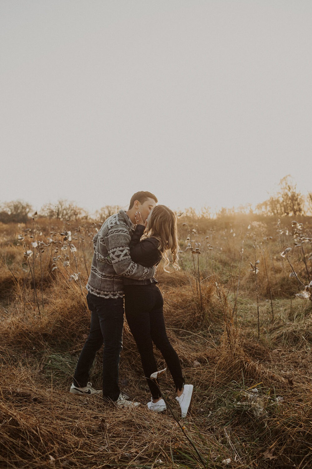couple kisses in field for Rock Creek Park photos