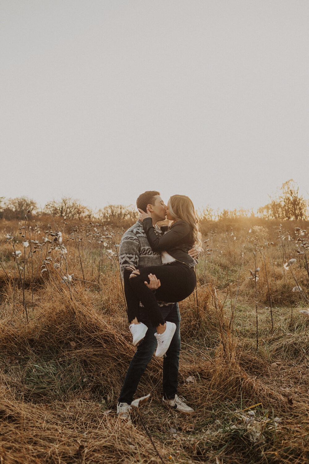 couple kisses in field for Rock Creek Park photos