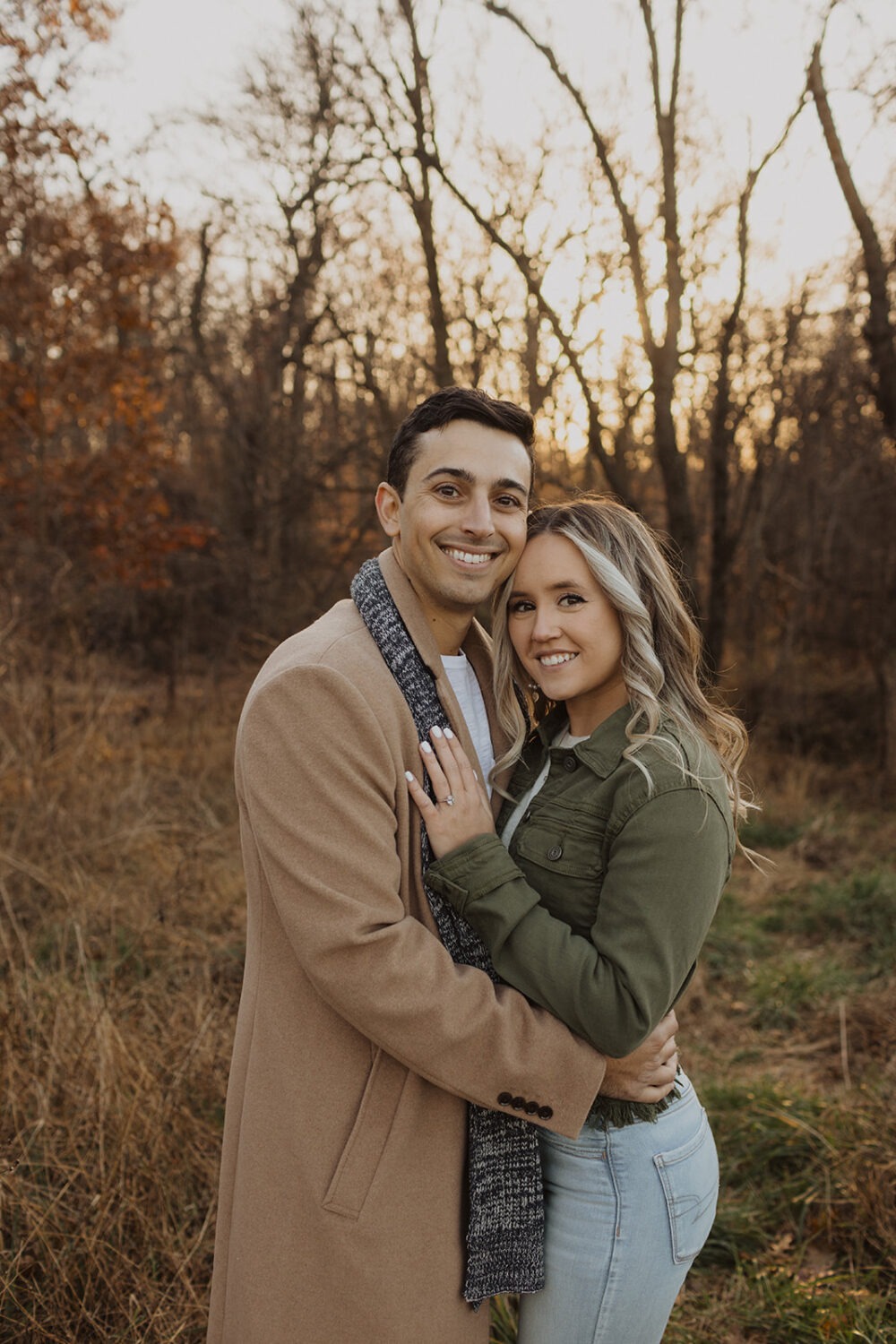 couple embraces at sunset woods engagement session 