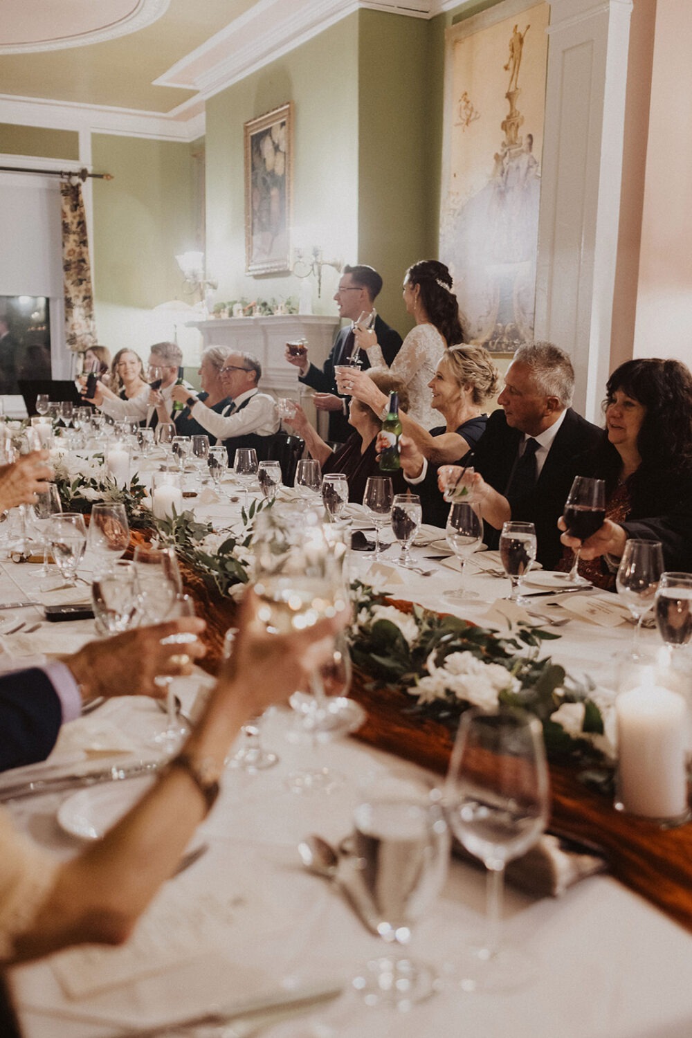couple and guests do toasts during wedding reception 