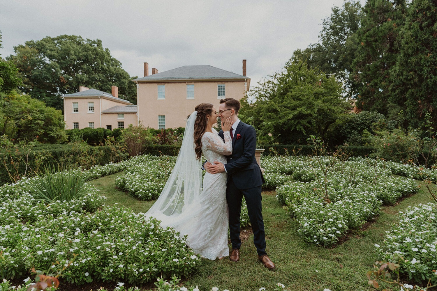 couple kisses in garden at Tudor Place Washington DC