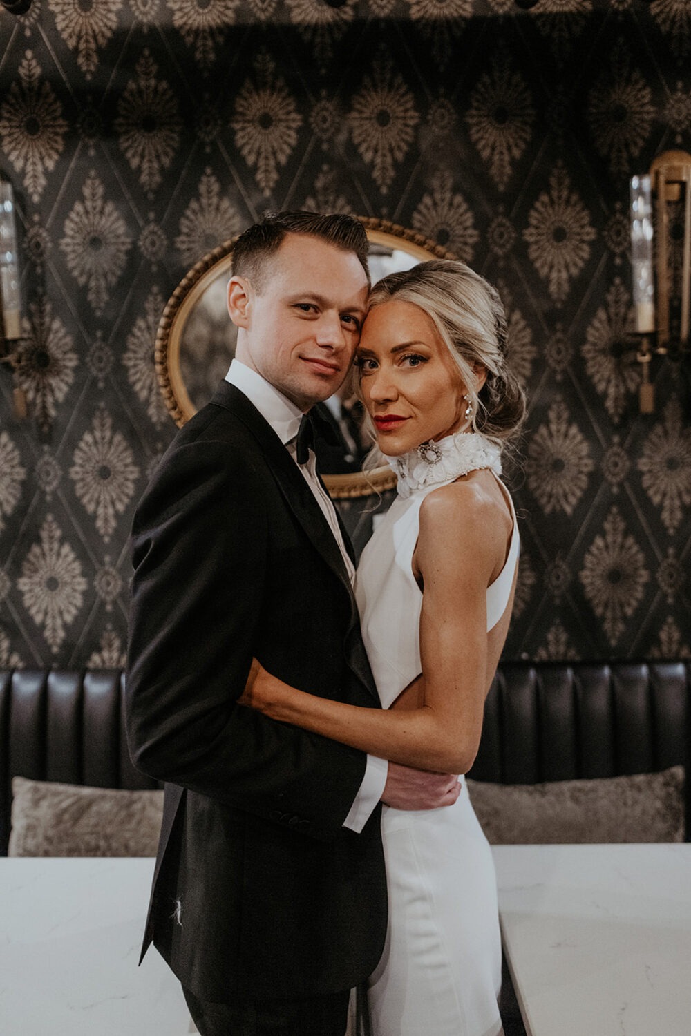 couple embraces at hotel bar wedding first look