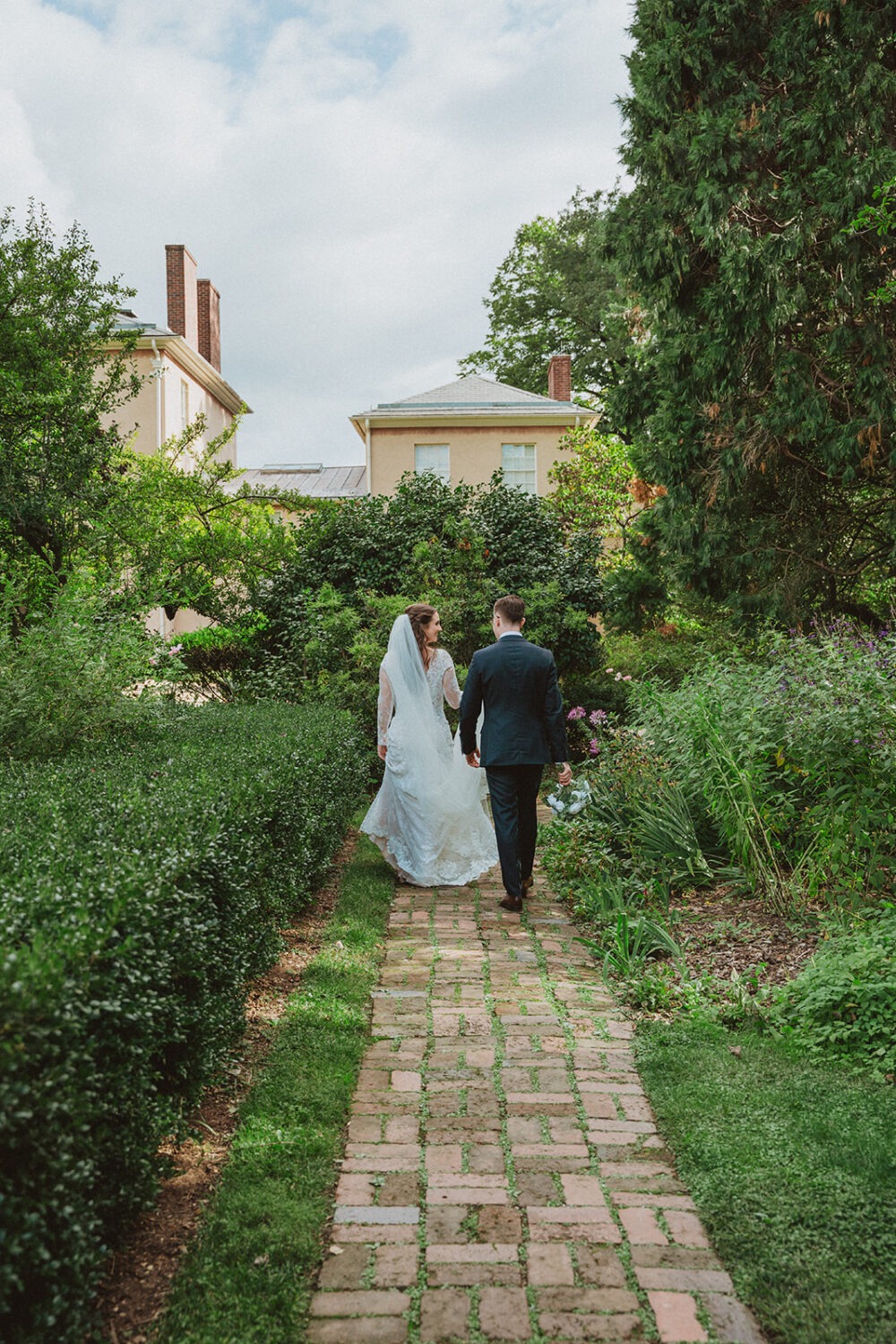 couple walks along garden path at Tudor Place Washington DC