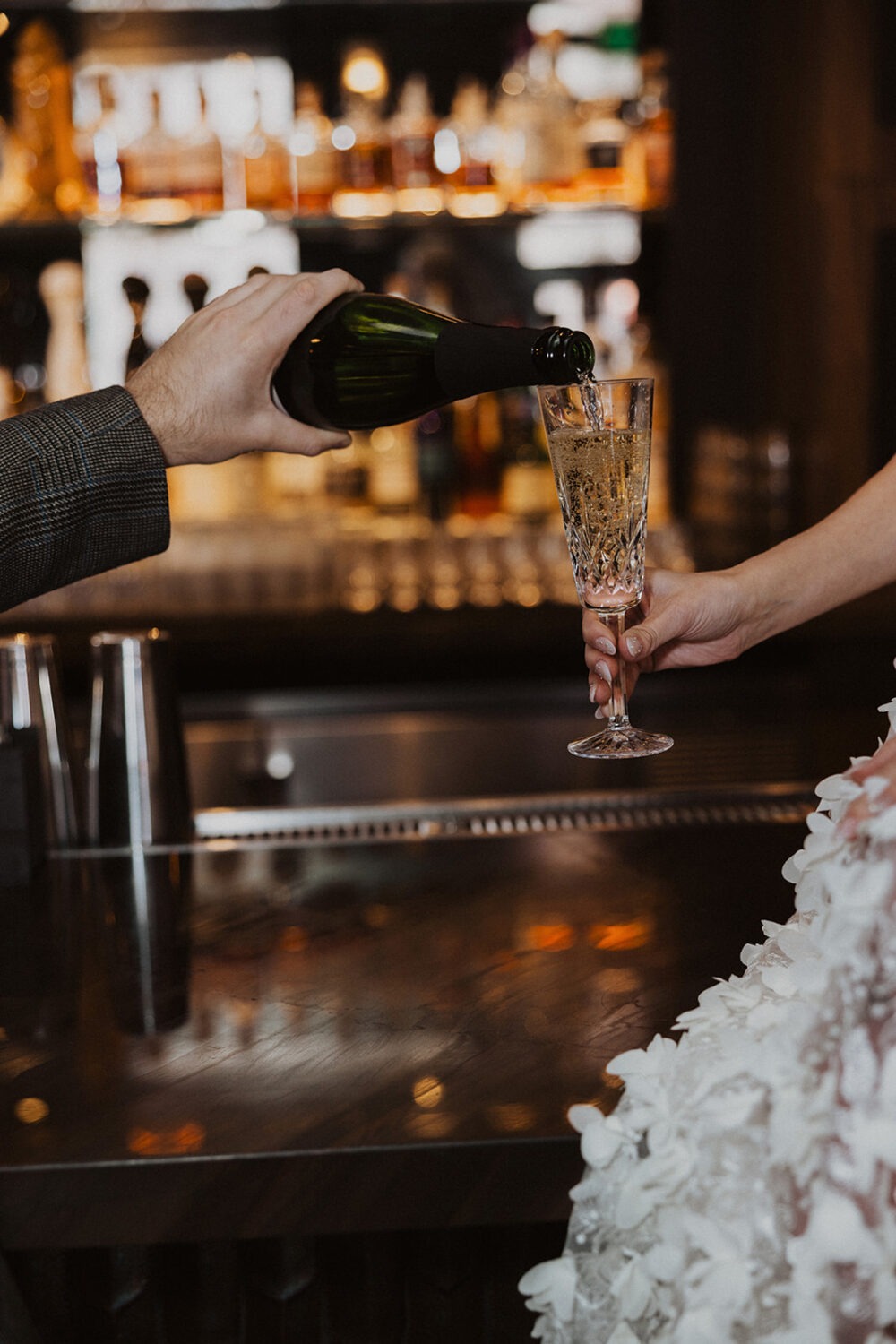 couple pours champagne at cocktail bars in DC