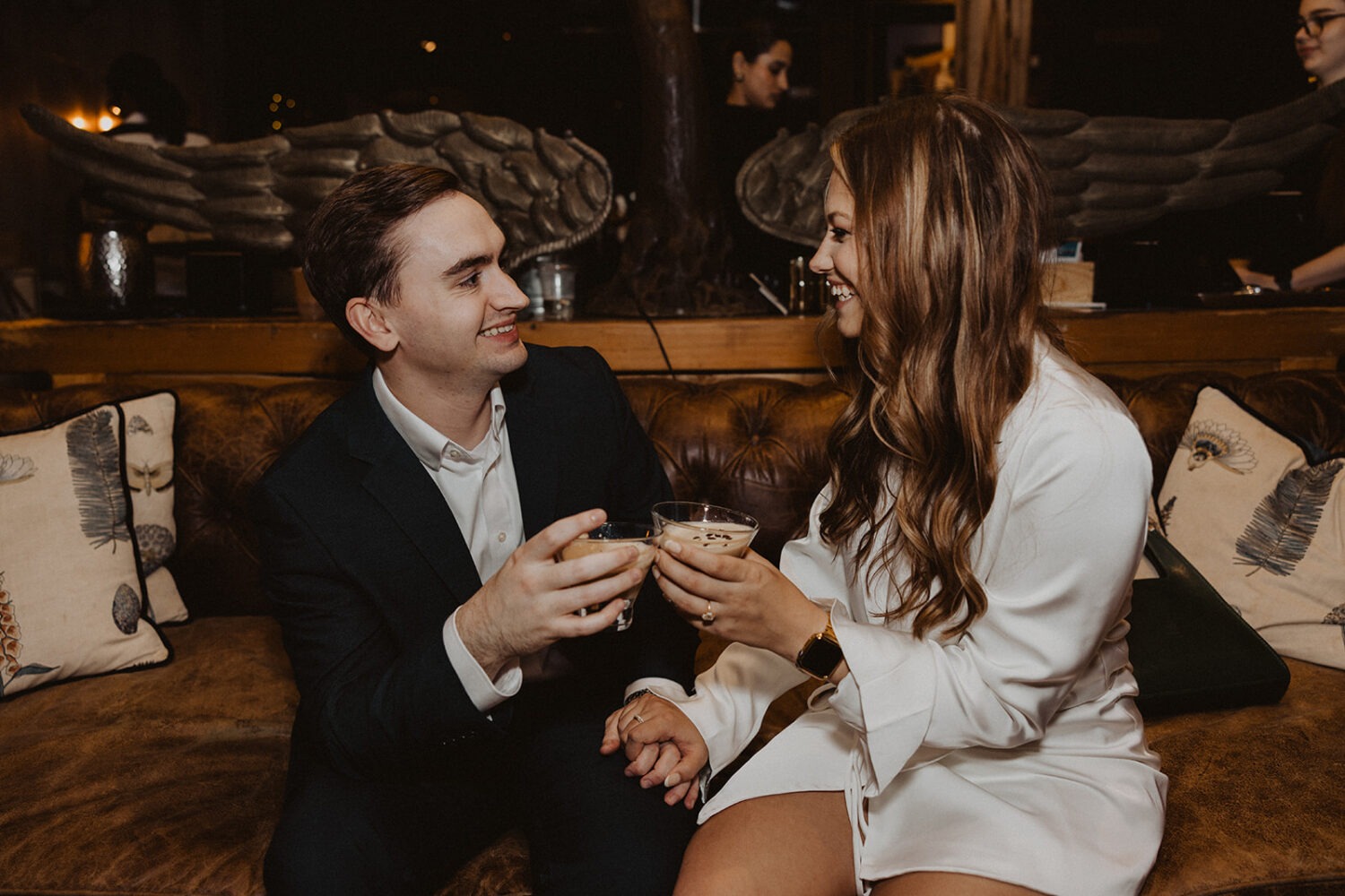 couple drinks cocktails at bar engagement session 