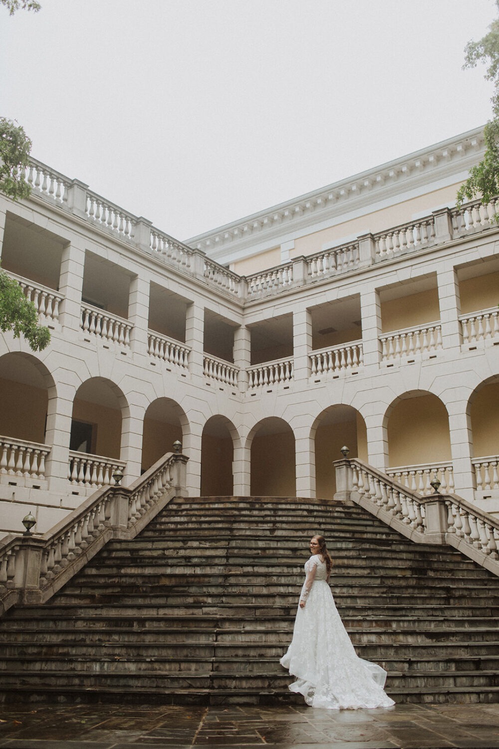 bride walks up staircase at Airlie Virginia wedding venue 