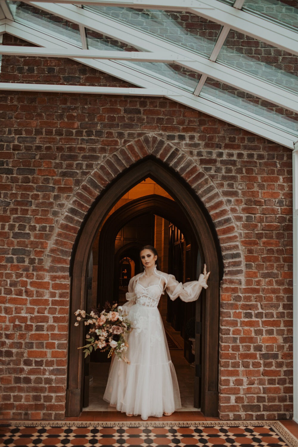 bride poses against door during  bridal portraits