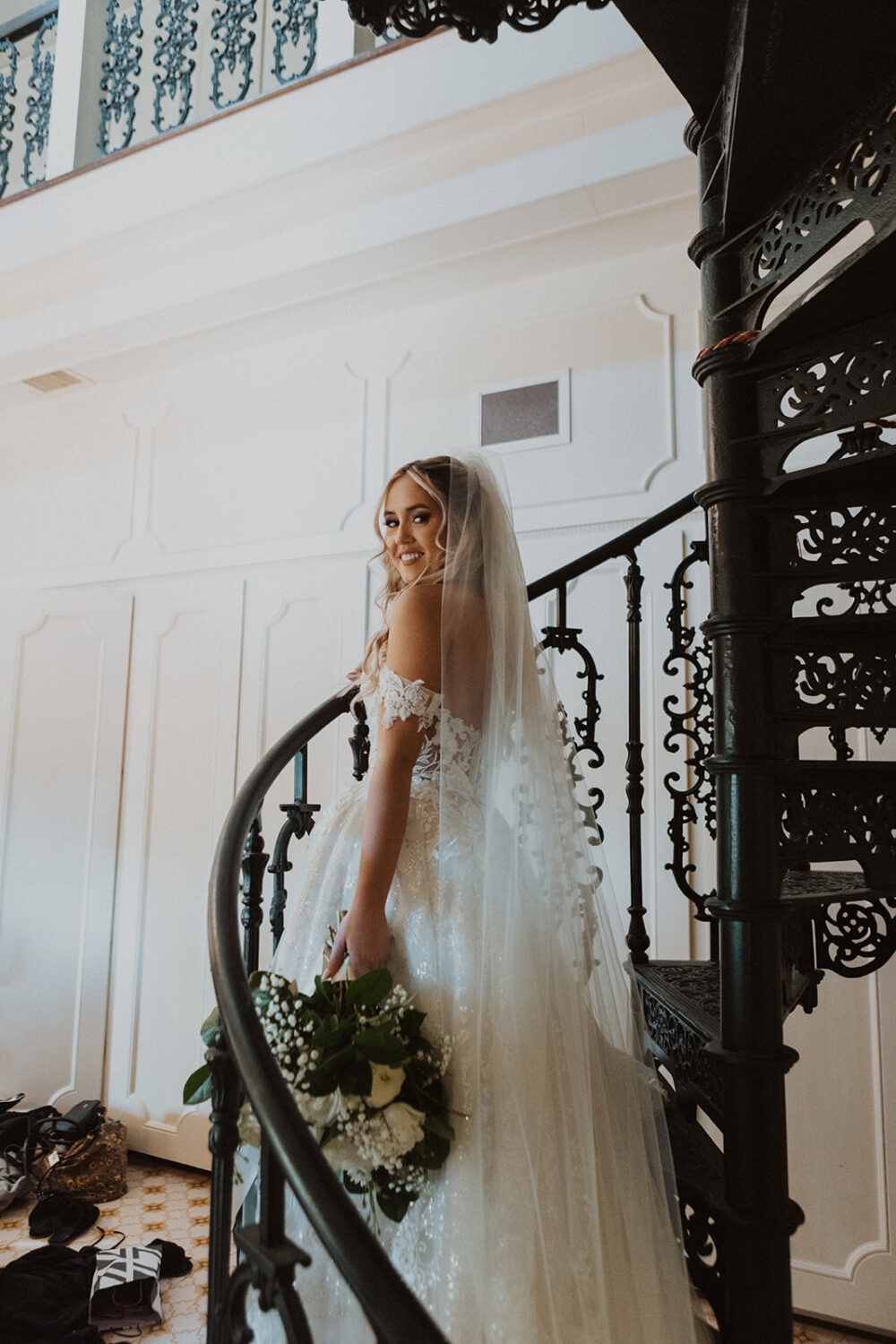 bride poses on staircase during  bridal portraits