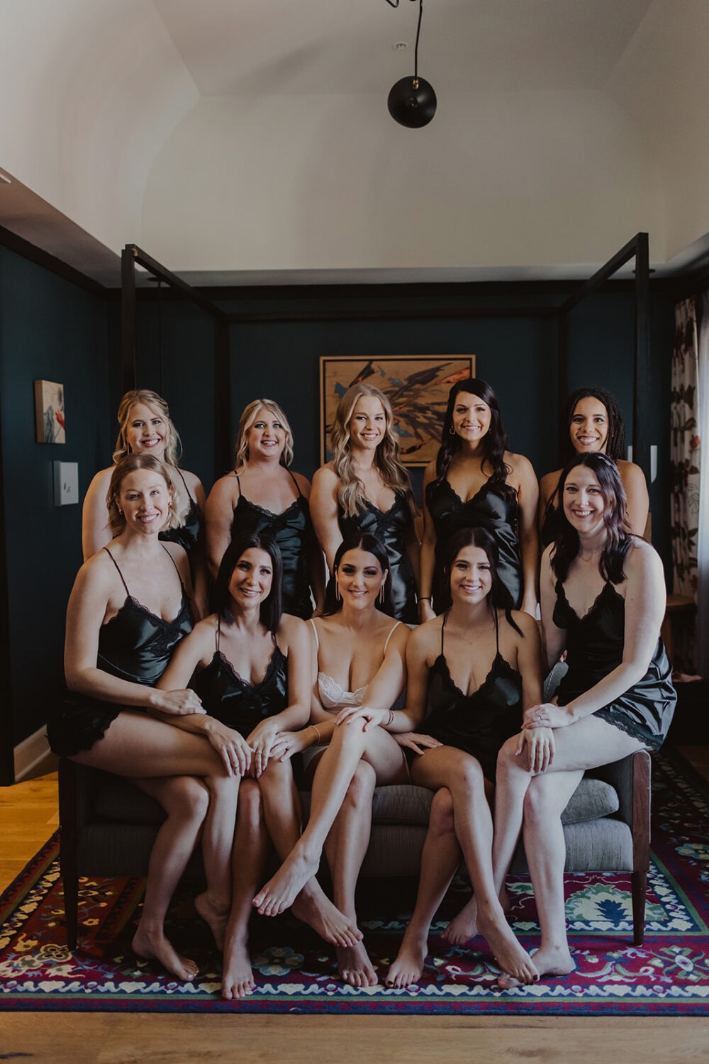 bride sits with bridesmaids wearing matching lingerie