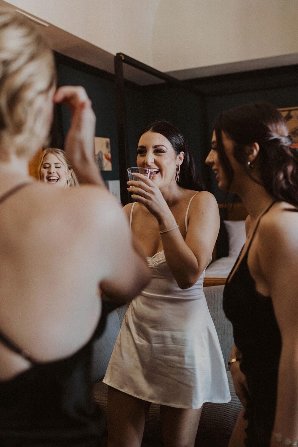 bride laughs with bridesmaids wearing matching lingerie