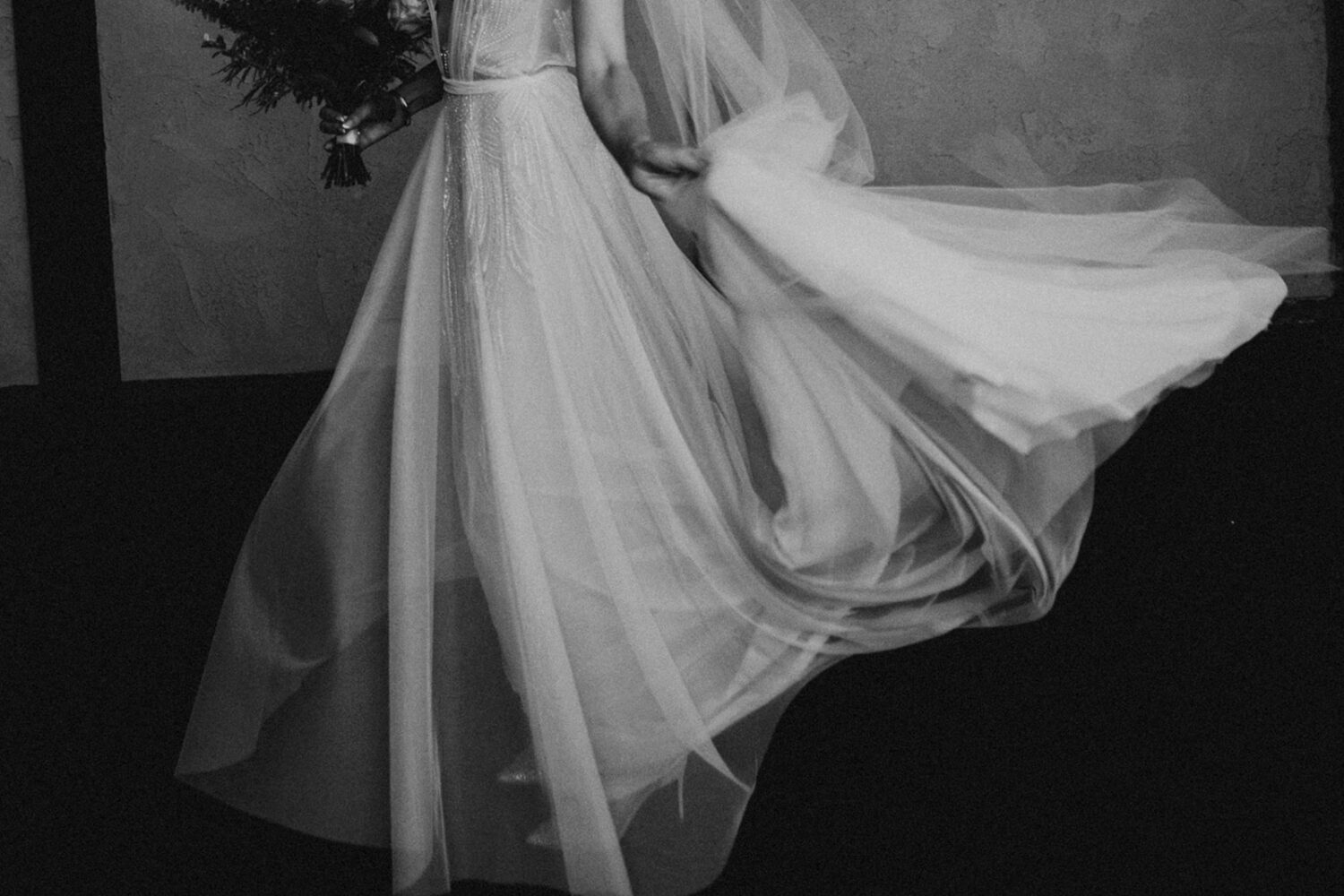 bride twirls white tulle wedding dress during  bridal portraits