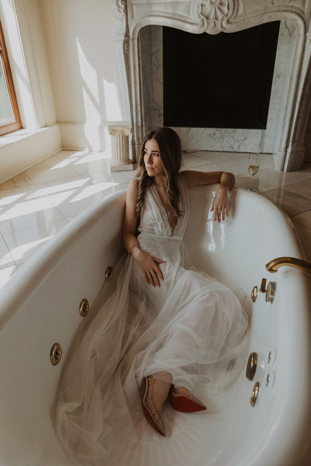 bride poses in tub during  bridal portraits