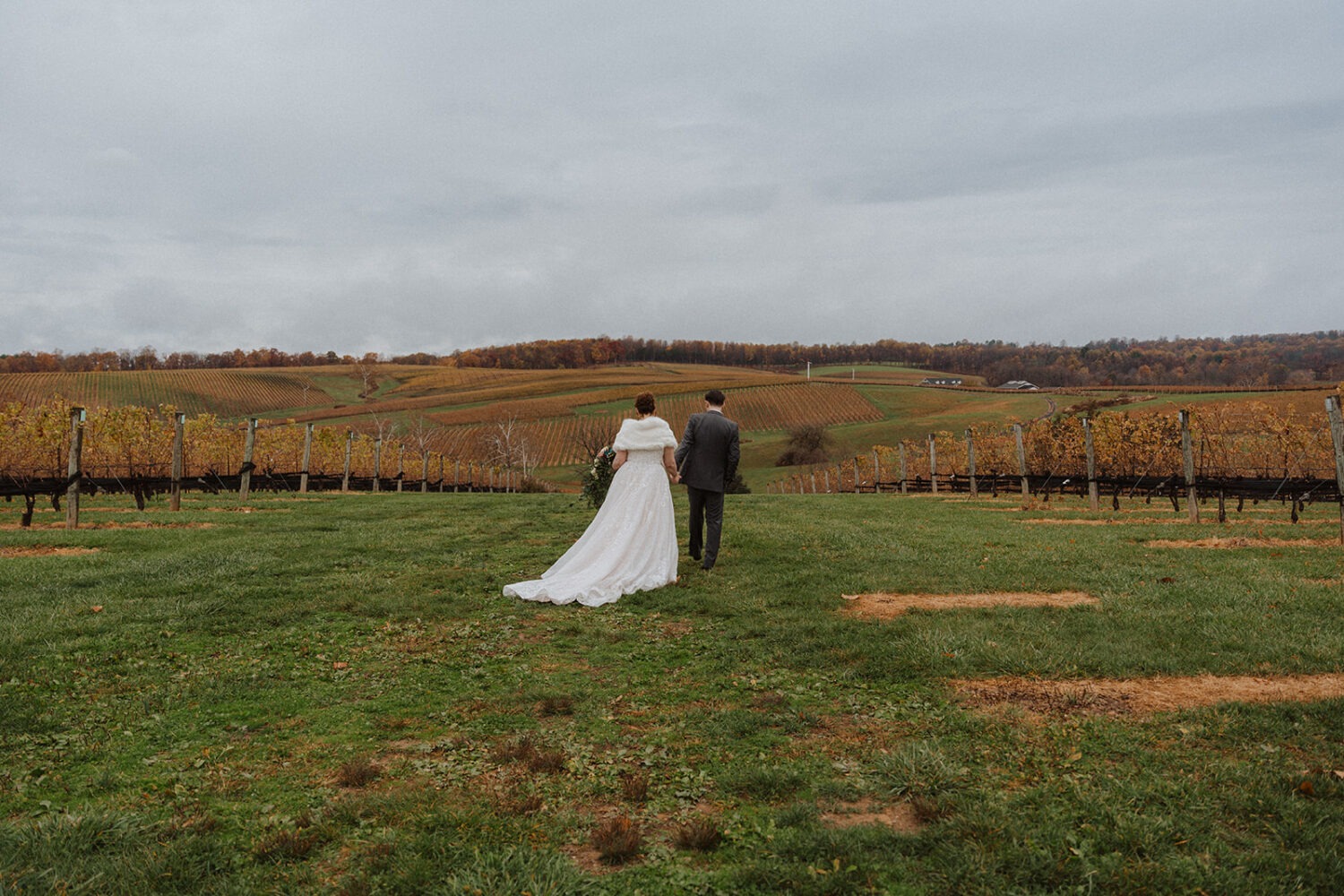 couple walks through outdoor vineyard following wedding planning tips and advice