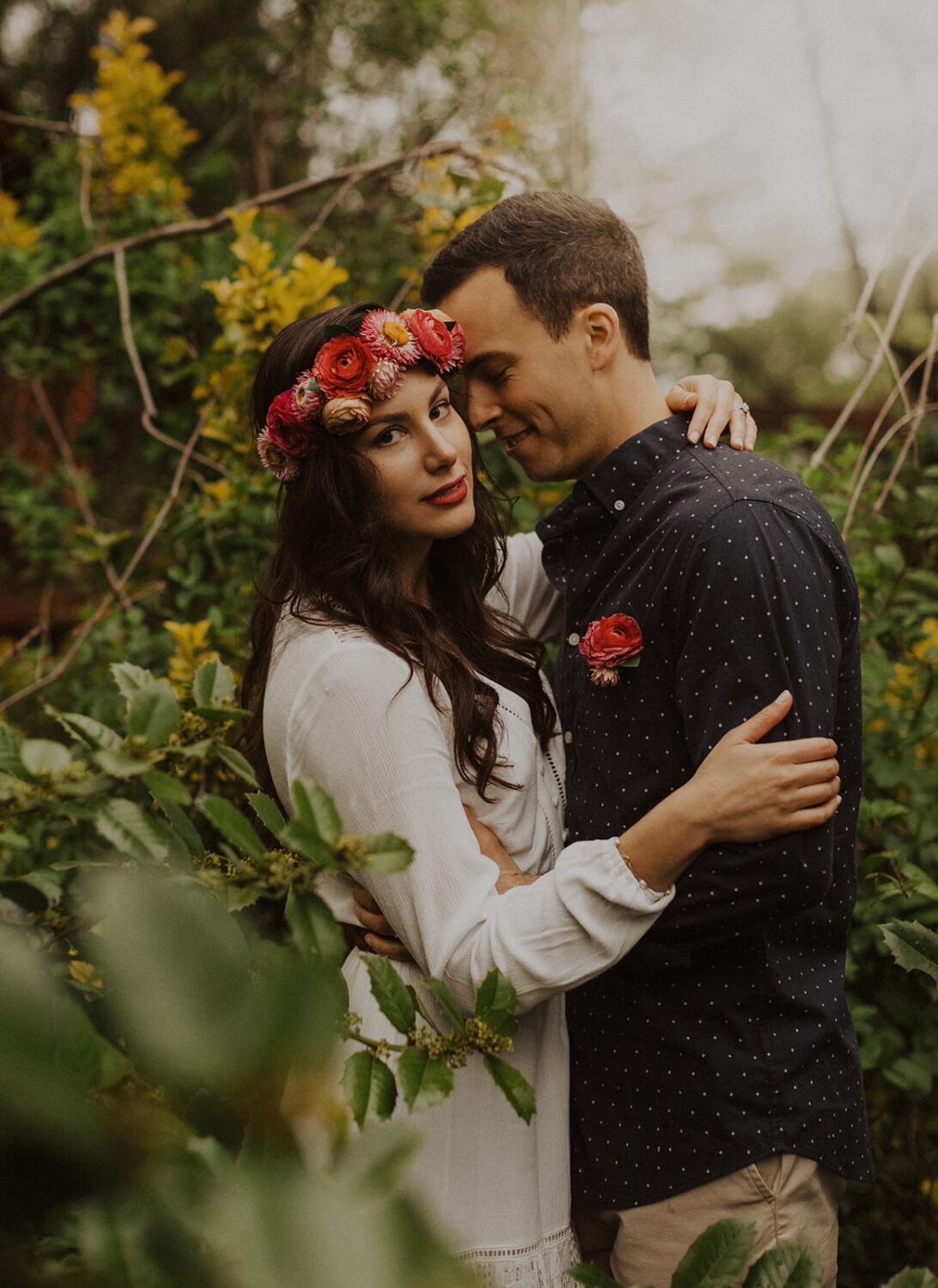 couple poses in garden at spring engagement photos
