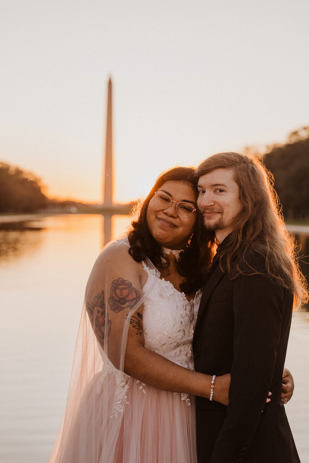 couple embraces at Lincoln Memorial sunrise