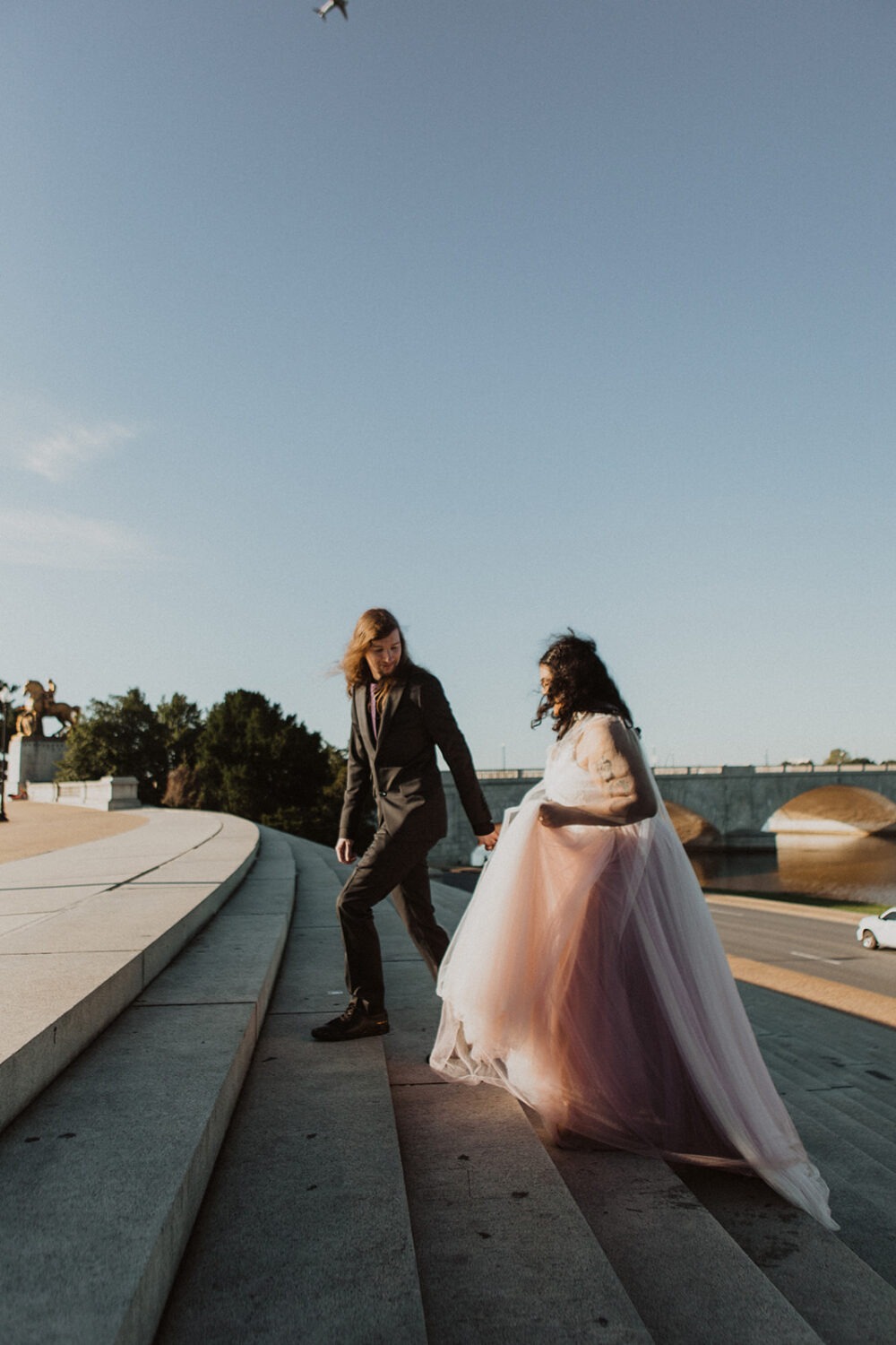 couple walks steps at Lincoln Memorial sunrise 