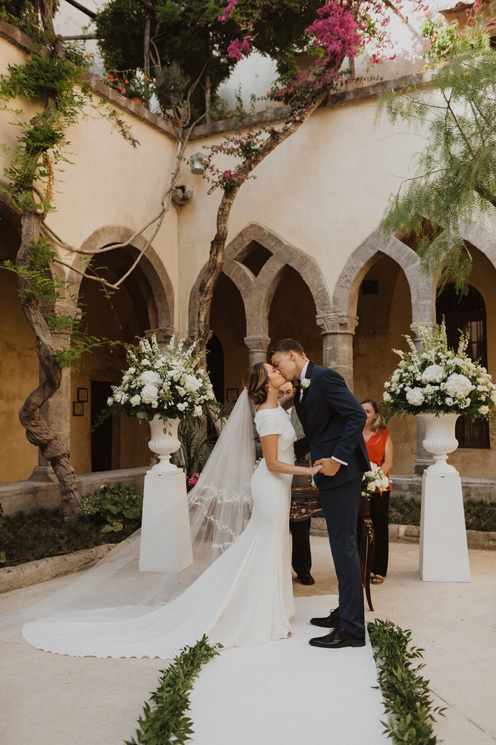 couple kisses during ceremony at Italy destination wedding 