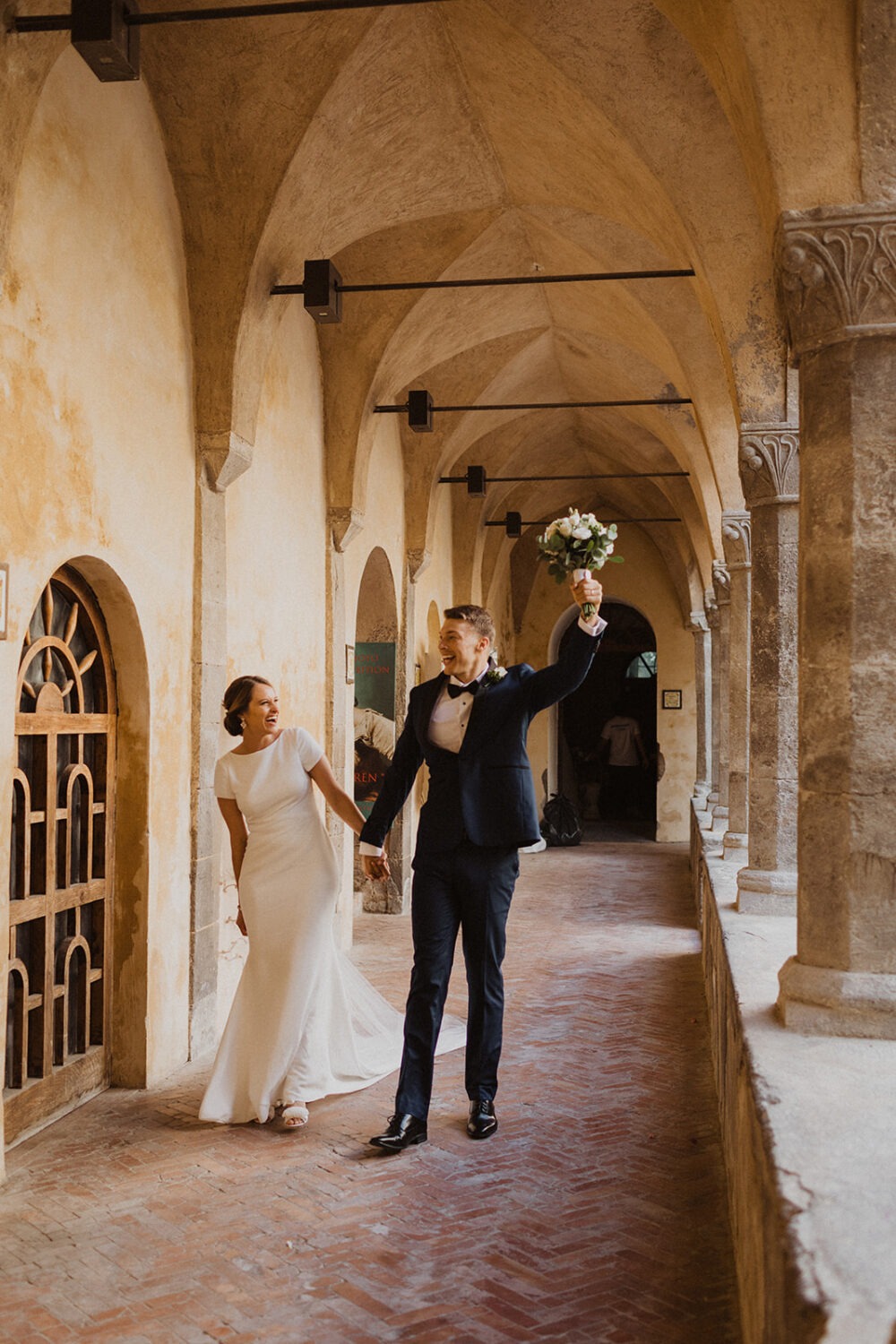 couple walks holding hands at Italy destination wedding 