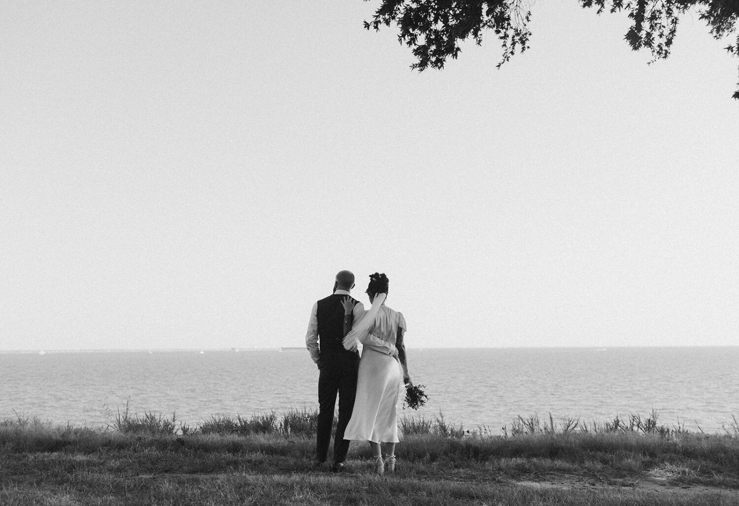 couple embraces at waterfront small wedding venue