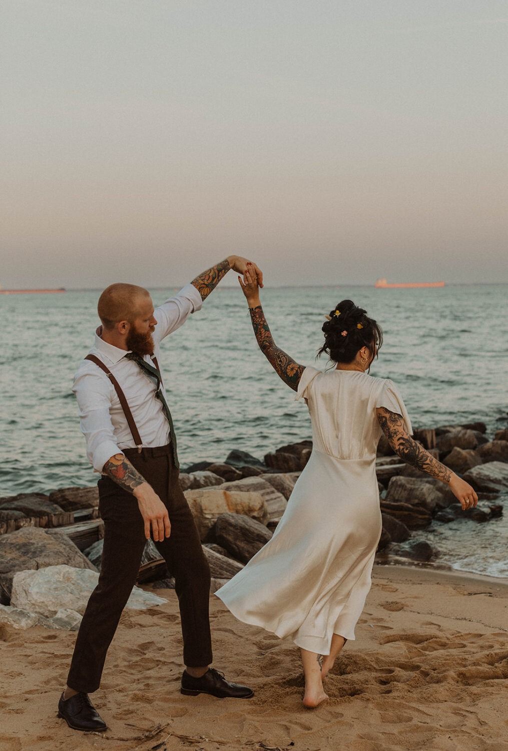 couple twirls at waterfront wedding venue