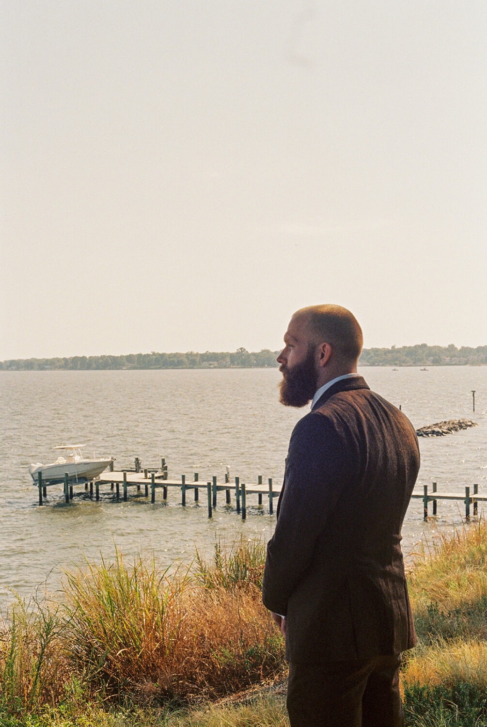 groom poses for portraits as part of photography wedding package