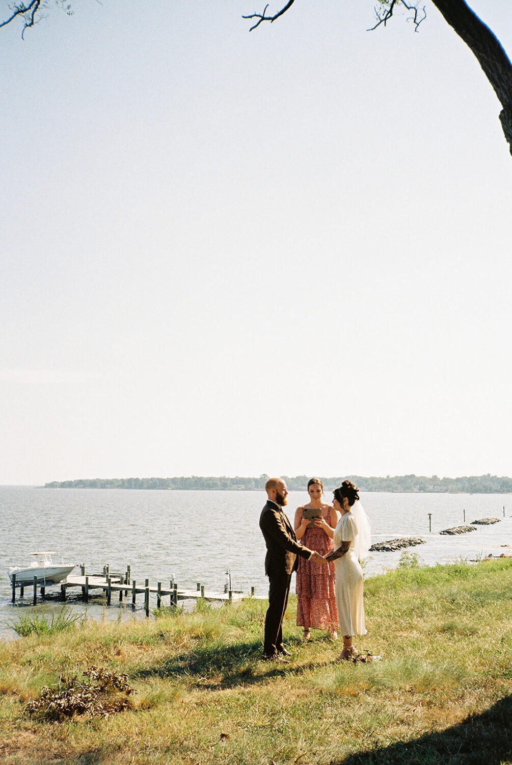 coupe exchanges vows at waterfront wedding venue