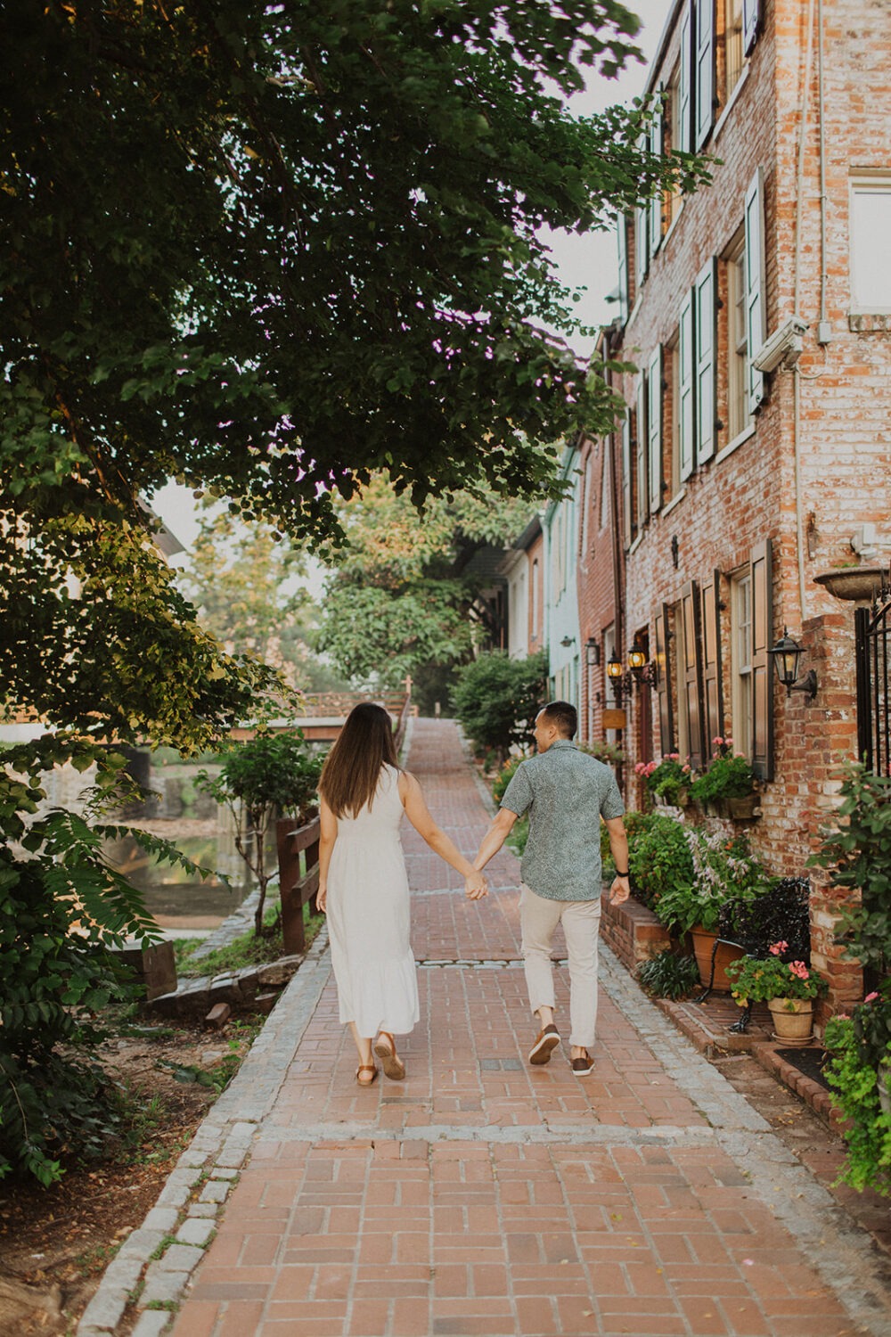 couple walks away holding hands at Georgetown engagement session