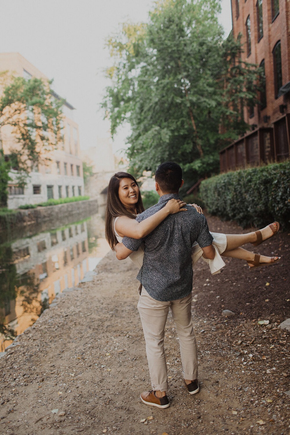 groom carries bride at Georgetown engagement session