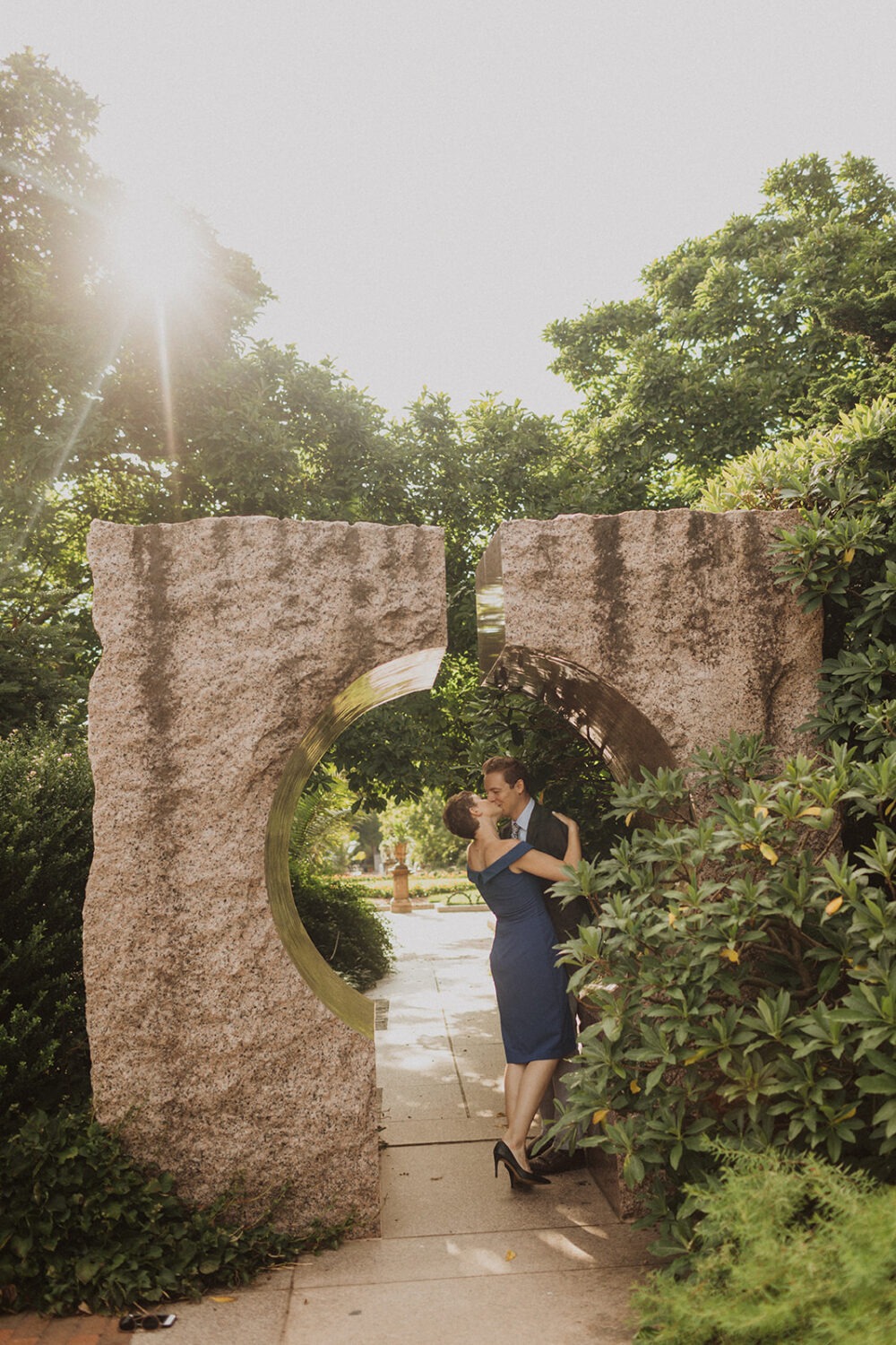 couple kisses at Smithsonian castle garden