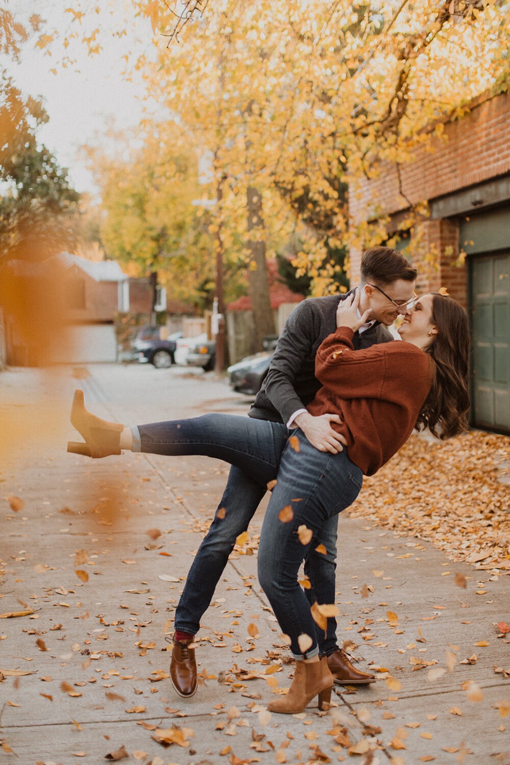 couple kisses during fall Georgetown engagement shoot photos