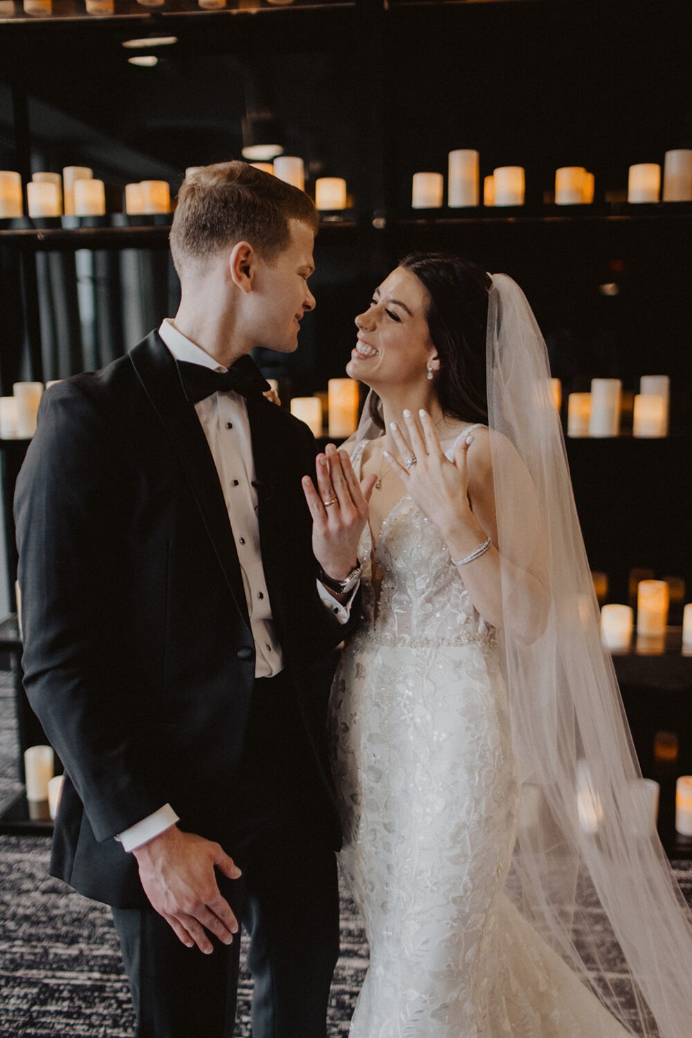 couple shows hands with wedding bands 