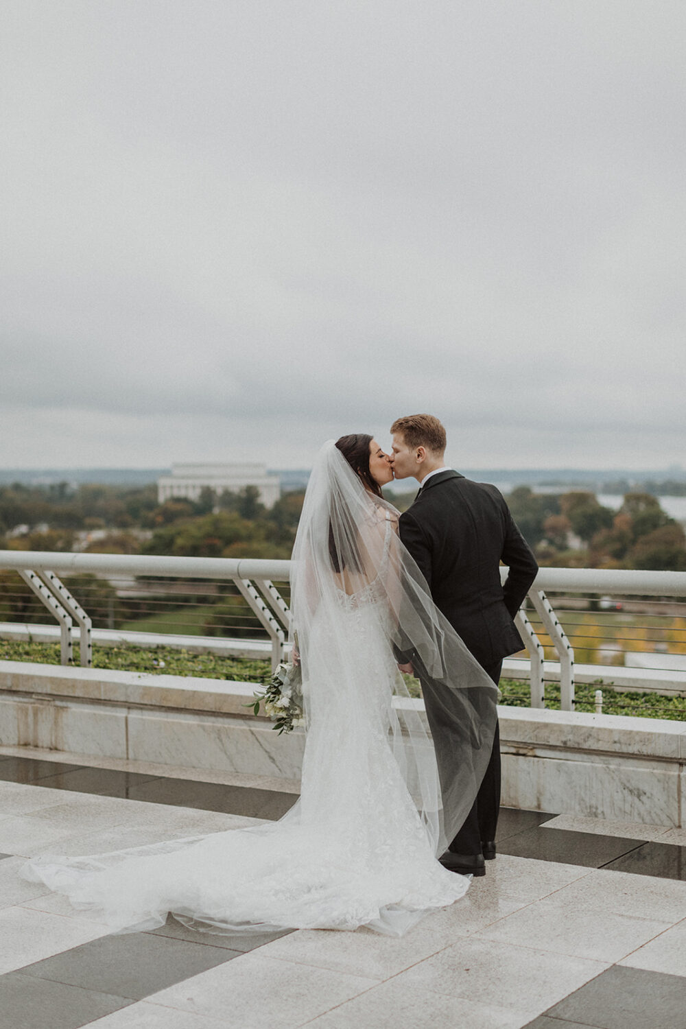 couple kisses at Washington DC Kennedy Center elopement