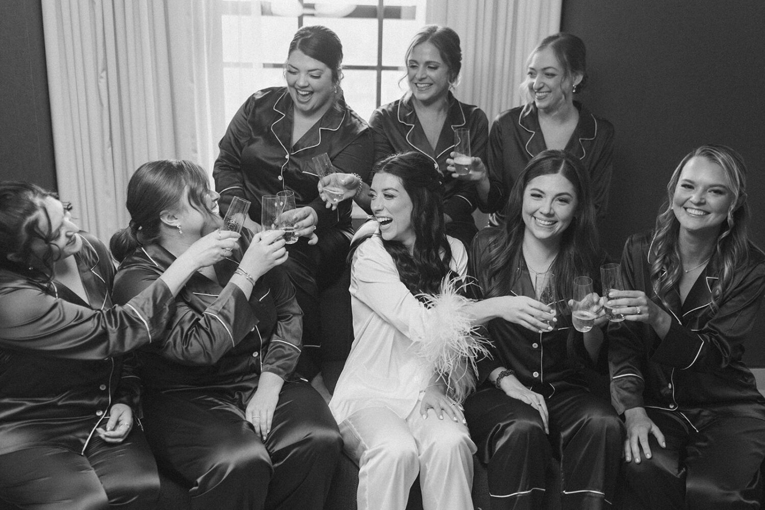 bride drinks in PJ's with bridesmaids 