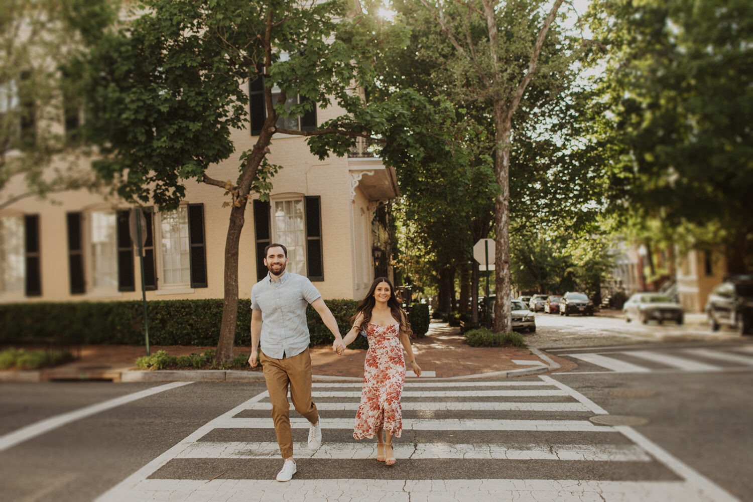 couple walks across street during Georgetown engagement shoot photos