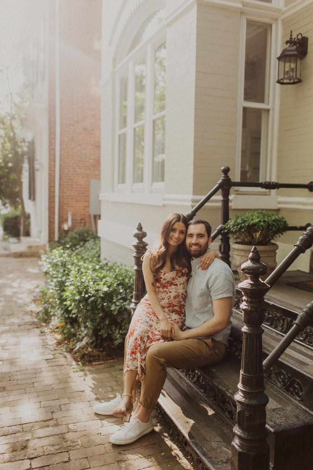 couple sits on stairs at Georgetown engagement session