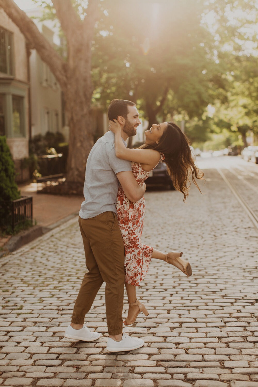 couple embraces on cobblestone Georgetown street 
