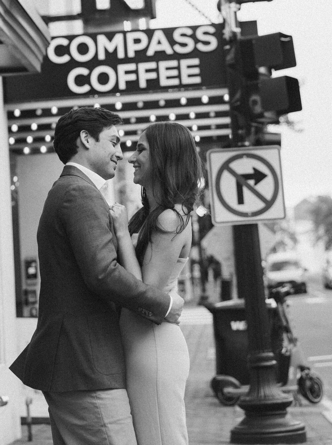 couple kisses at DC coffee shop engagement session