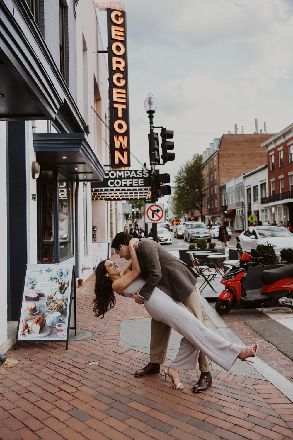 couple kisses on street at Georgetown engagement session