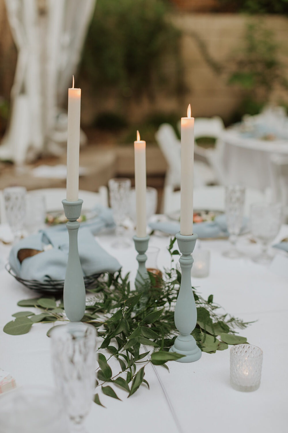 white candles and blue candlesticks wedding decor 