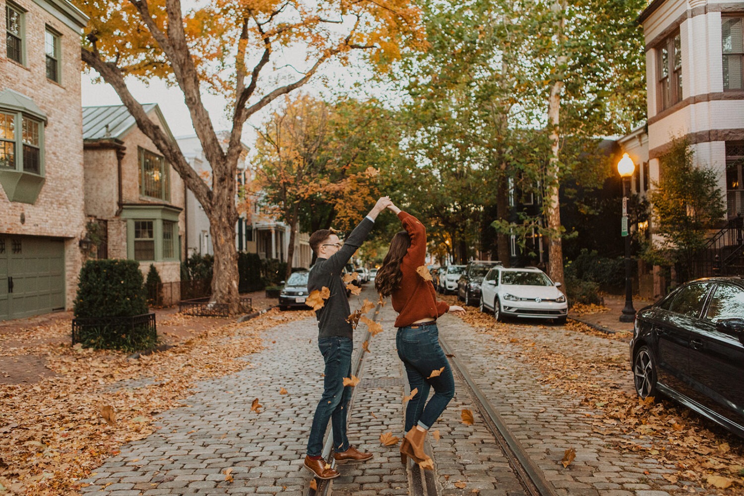couple twirls during fall Georgetown engagement shoot photos 