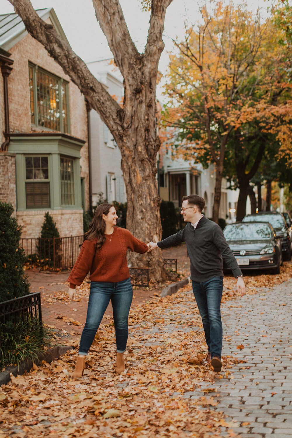 couple walks holding hands during Georgetown engagement shoot photos