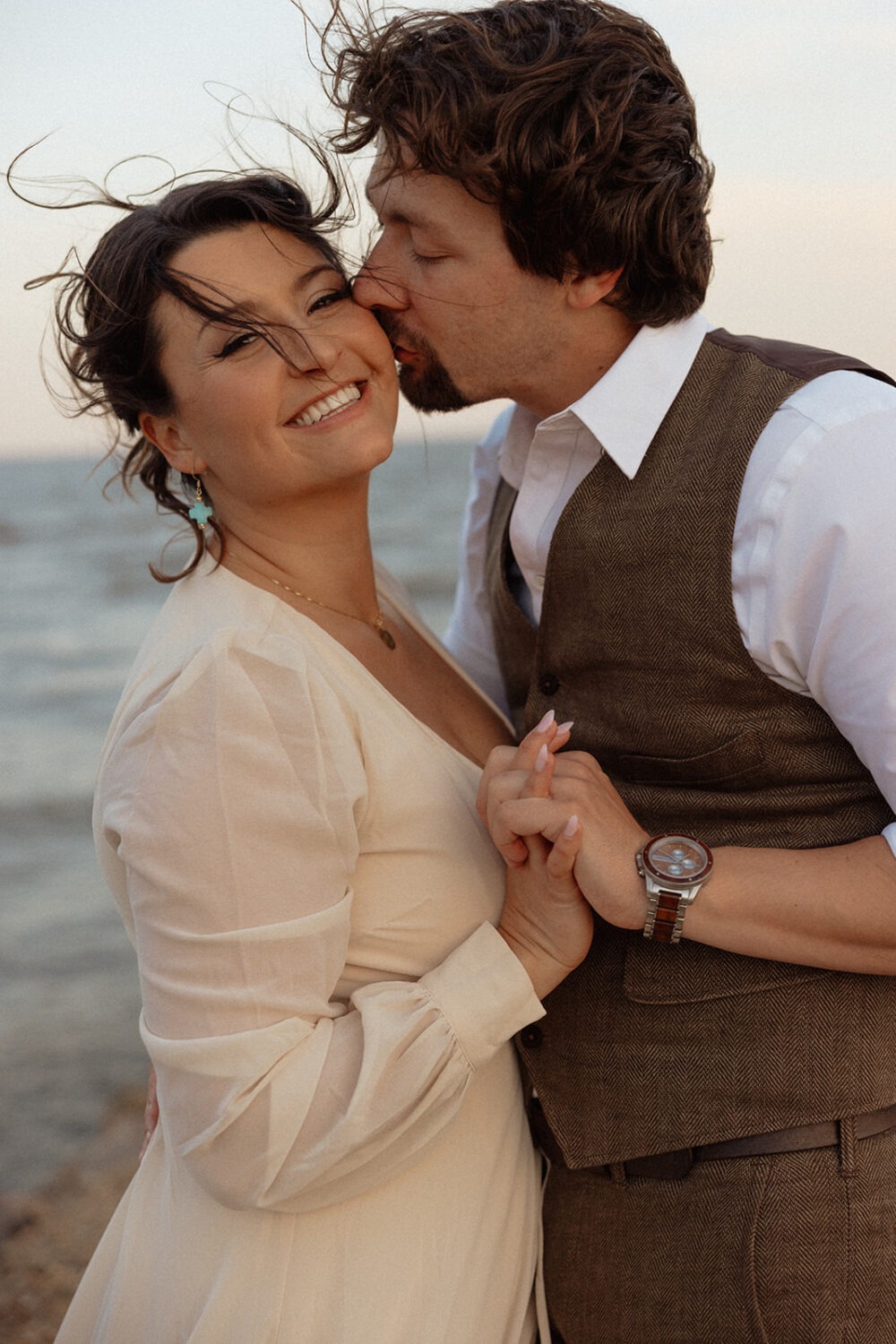 couple embraces at beach photo shoot